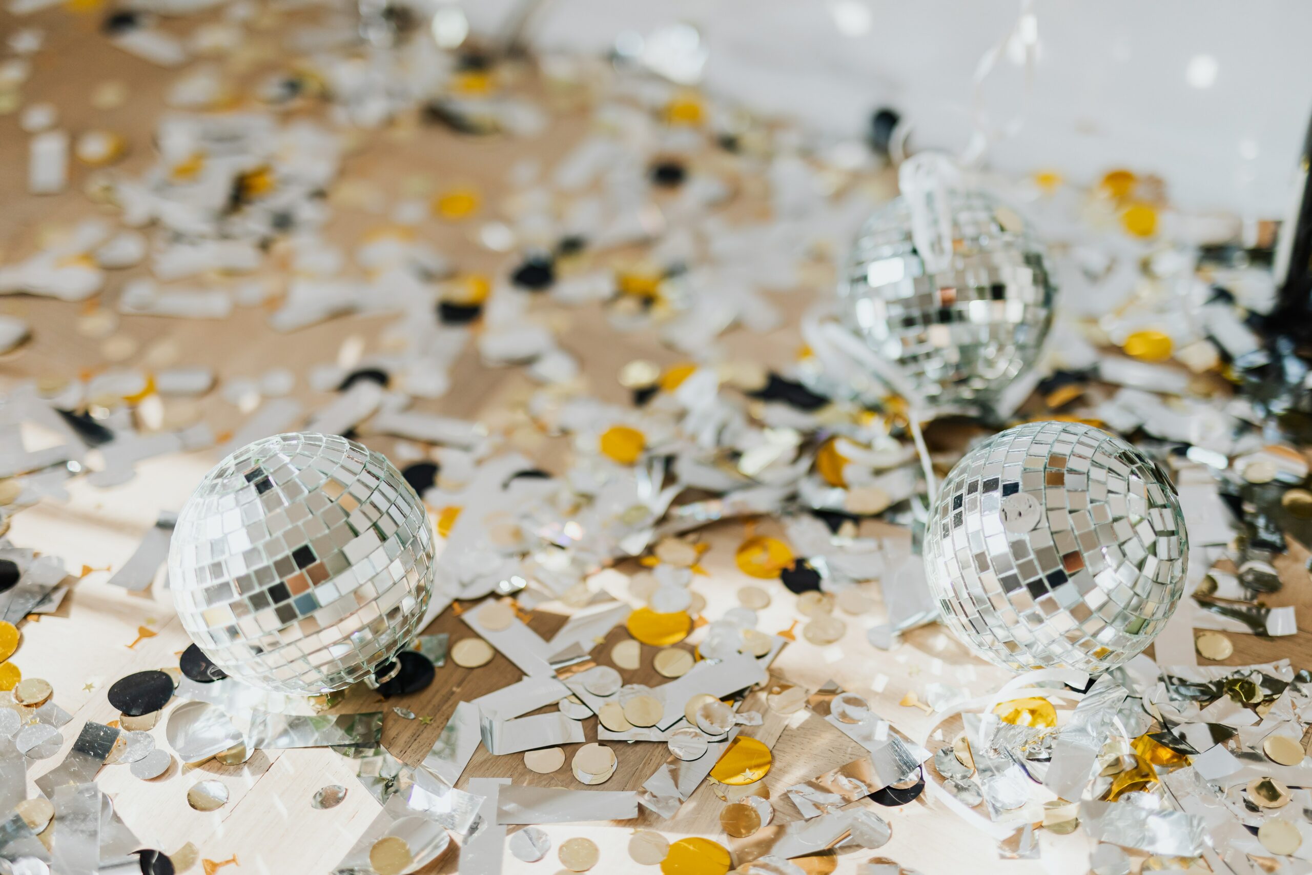A pile of silver and gold confetti and miniature disco balls.