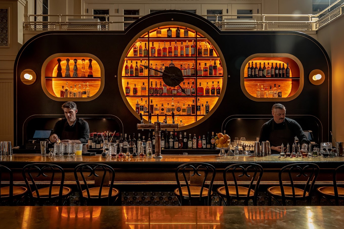 The black-and-gold barroom at Koloman, with a round central feature shaped like a clock face.