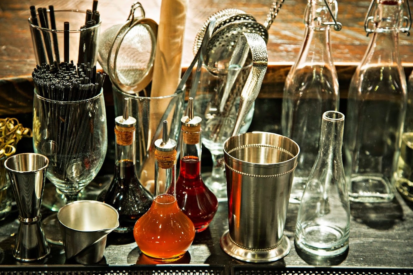 A selection of amber liquids in bottles and other glassware at McClellan’s Retreat.