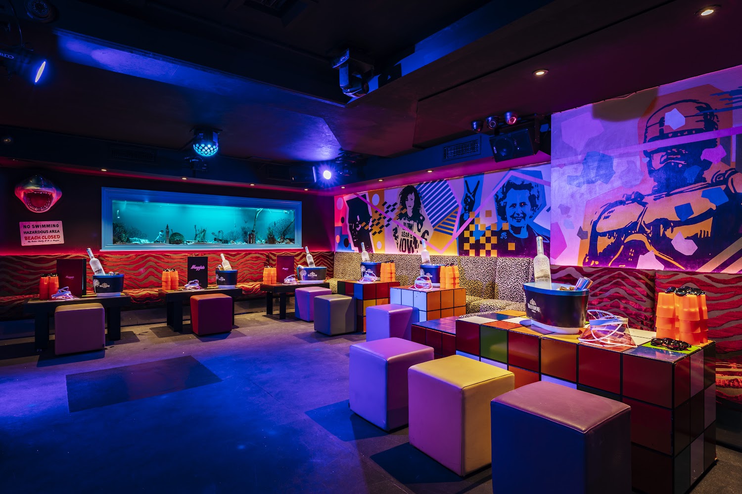 1980's theme interior of maggie's club, including rubix cube table, giant 80s fish tank and retro lighting system