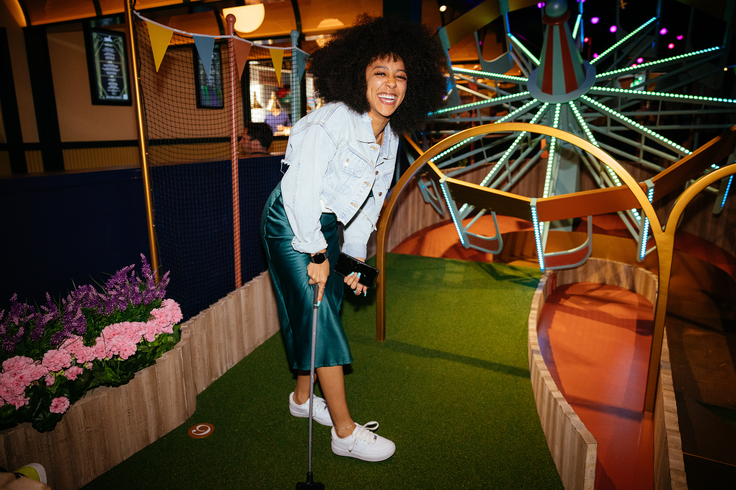 Woman laughs on crazy golf course
