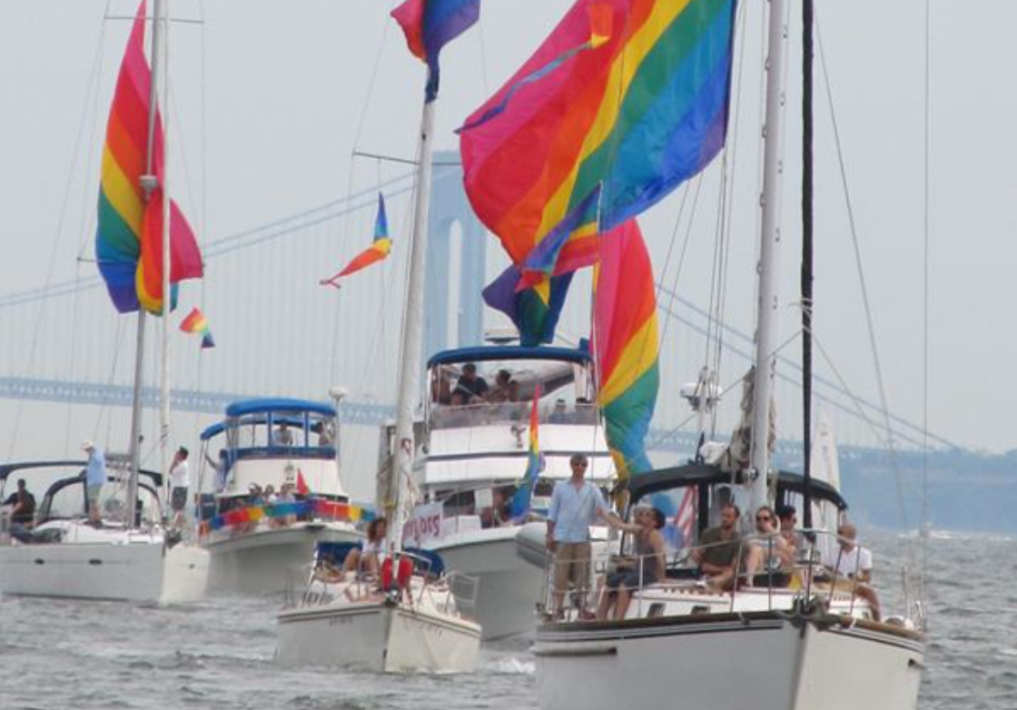 Boats with rainbow flags sailing on the Hudson River.