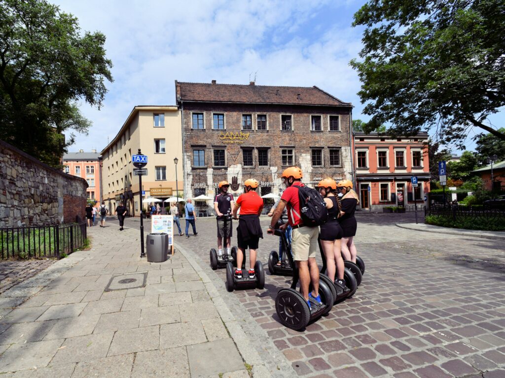 people on segways travelling through cobble street