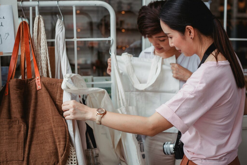 Trendy asian woman choosing clothes 