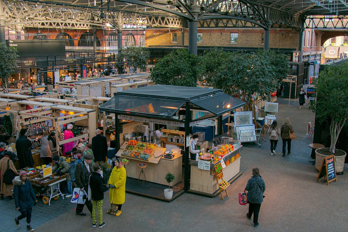 a picture of the spitalfields market featuring a greens stall and a vintage looking market