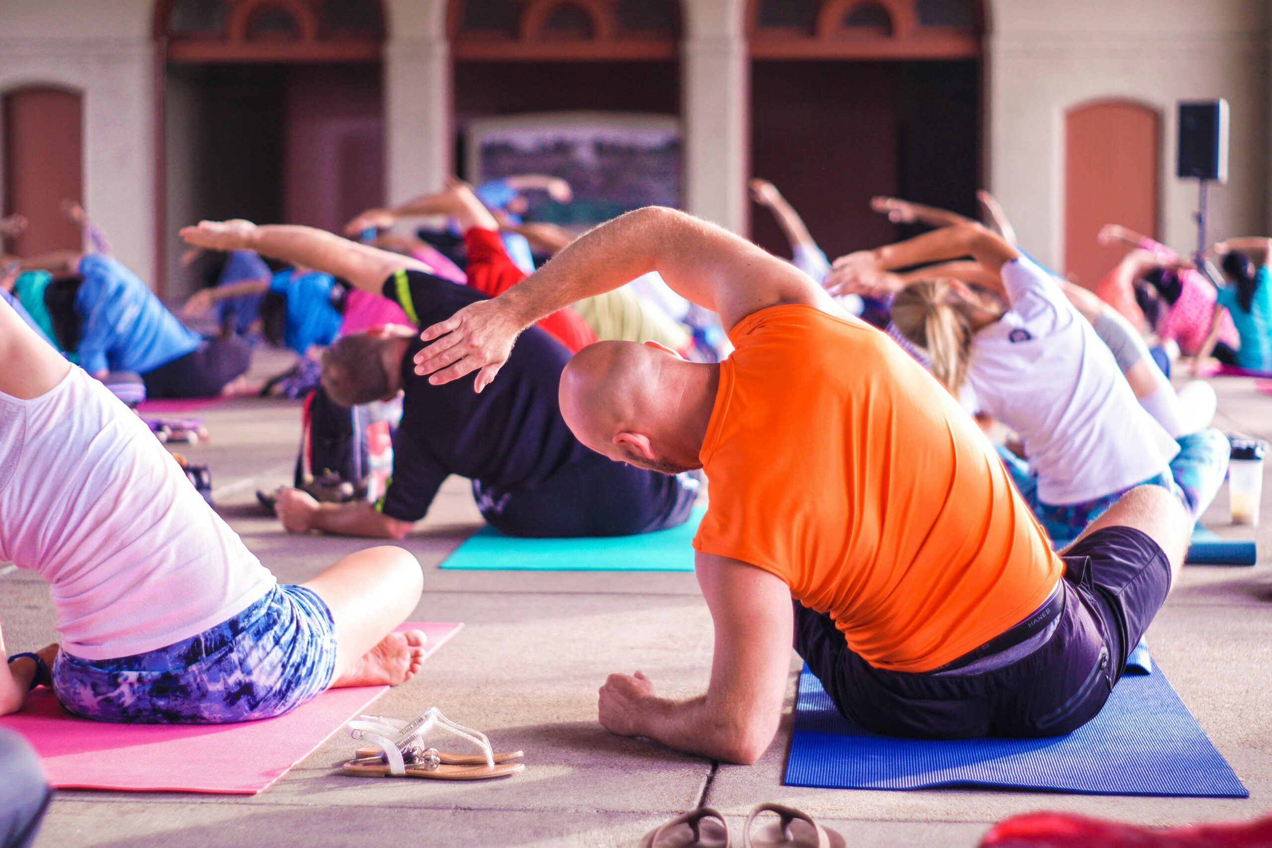 people in colourful outfits stretching doing yoga