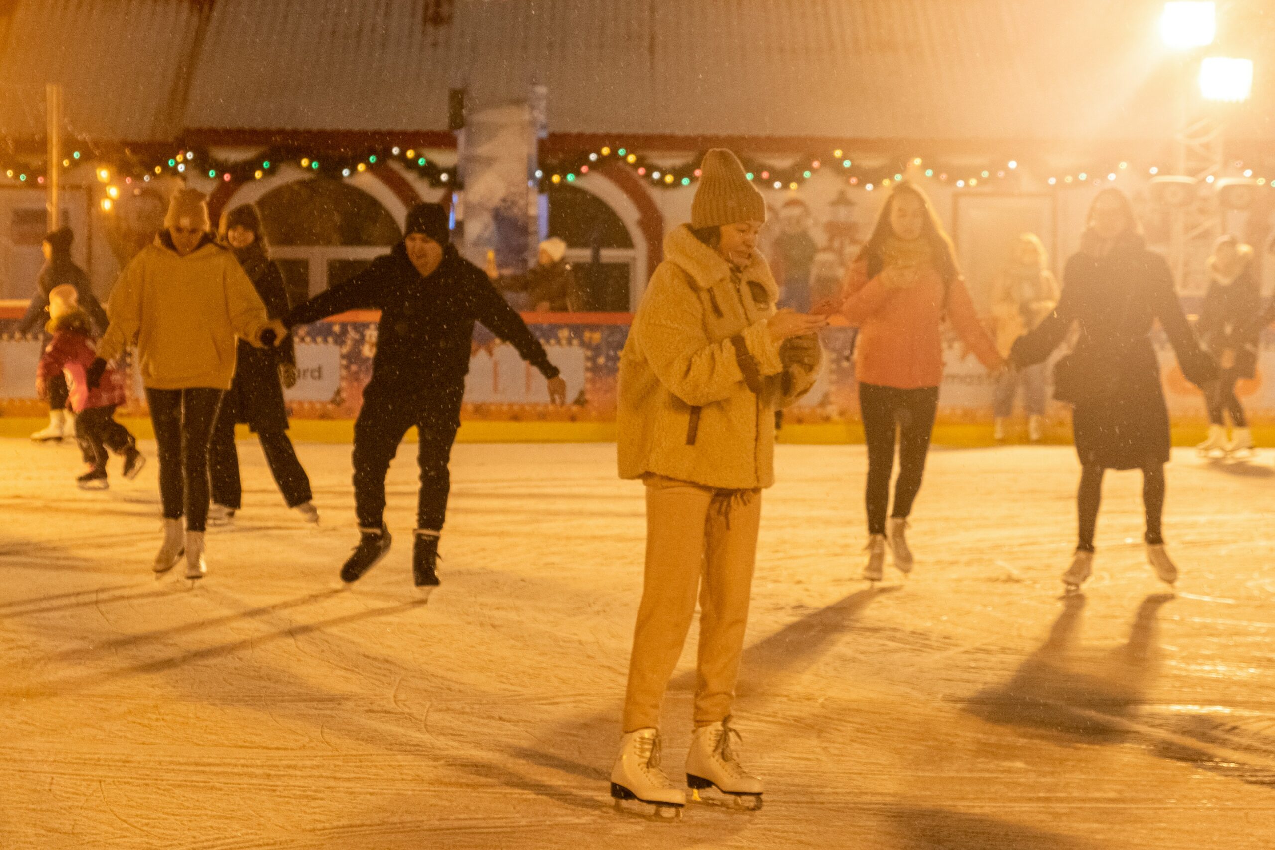 people ice skating around an ice rink